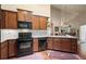 A well-lit kitchen features wooden floors, stainless steel appliances and light countertops at 803 Brookhavenrun Cir, Duluth, GA 30097