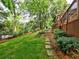 Lush backyard with mature trees and stone walkway at 1257 Independence Way, Marietta, GA 30062