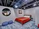 Cozy basement bedroom with colorful blue accents and exposed ceiling at 1257 Independence Way, Marietta, GA 30062