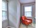 Bright bedroom nook featuring a cozy orange chair by a window with natural light at 1257 Independence Way, Marietta, GA 30062