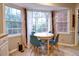 Bright breakfast nook features a bay window, a round table, and four modern chairs at 1257 Independence Way, Marietta, GA 30062