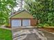 Home featuring a two-car garage, a paved driveway and manicured landscaping adding curb appeal at 1257 Independence Way, Marietta, GA 30062