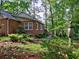 Rear exterior of a well-maintained brick home with lush landscaping and mature trees at 1257 Independence Way, Marietta, GA 30062