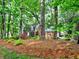Inviting exterior of a brick home nestled among mature trees, creating a private and picturesque setting at 1257 Independence Way, Marietta, GA 30062