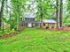 Charming two-story brick home with a lush green lawn and mature trees, offering great curb appeal at 1257 Independence Way, Marietta, GA 30062