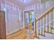 Bright foyer featuring hardwood floors, a staircase with white railings and views into the living area at 1257 Independence Way, Marietta, GA 30062