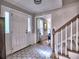 Bright foyer with tile flooring, staircase, and open view to living area at 1257 Independence Way, Marietta, GA 30062