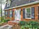 Charming brick home with black shutters, trimmed landscaping, and a welcoming front entrance at 1257 Independence Way, Marietta, GA 30062