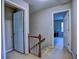 Upstairs hallway leading to bedrooms with carpet flooring and a wooden banister at 1257 Independence Way, Marietta, GA 30062