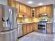 Well-appointed kitchen with stainless steel appliances, oak cabinets, and tile flooring at 1257 Independence Way, Marietta, GA 30062