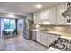 Bright kitchen features white cabinetry, stainless steel appliances and a breakfast nook at 1257 Independence Way, Marietta, GA 30062