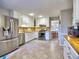 Spacious kitchen featuring stainless steel appliances, white cabinets and an adjacent breakfast area at 1257 Independence Way, Marietta, GA 30062