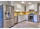 Modern kitchen with stainless steel appliances, white cabinets, and tile backsplash at 1257 Independence Way, Marietta, GA 30062