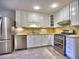 Bright kitchen features stainless steel appliances, white cabinets, and tiled floor at 1257 Independence Way, Marietta, GA 30062