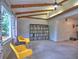 Cozy living area with beamed ceilings, large window and yellow chairs at 1257 Independence Way, Marietta, GA 30062