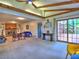 Open living room features carpet flooring, a brick fireplace, beamed ceilings, and sliding doors to a deck at 1257 Independence Way, Marietta, GA 30062