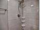 Updated bathroom shower featuring dual shower heads and a convenient corner shelf at 1257 Independence Way, Marietta, GA 30062