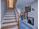 Staircase leading to the upper level with carpet and decorative wall art at 1257 Independence Way, Marietta, GA 30062