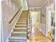 Staircase with wooden handrail and carpeted steps leading to the upper level of the home at 1257 Independence Way, Marietta, GA 30062