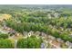 Aerial view of a beautiful home nestled within a lush, tree-filled neighborhood near a lake and golf course at 1405 Arden Trace Ln, Lawrenceville, GA 30043