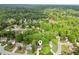 A broader aerial view highlights the house within a community surrounded by lush greenery at 1405 Arden Trace Ln, Lawrenceville, GA 30043