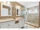 Bathroom with double vanity, marble countertops, tiled floors, and a glass-enclosed shower at 1405 Arden Trace Ln, Lawrenceville, GA 30043