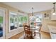Bright breakfast nook features hardwood floors, large windows, and a table with seating for four at 1405 Arden Trace Ln, Lawrenceville, GA 30043