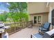 Spacious deck with chairs and a grill overlooking the backyard, perfect for relaxing and entertaining at 1405 Arden Trace Ln, Lawrenceville, GA 30043