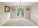 Neutral dining area with chandelier and access to the deck at 1405 Arden Trace Ln, Lawrenceville, GA 30043