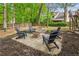 A charming backyard firepit area featuring Adirondack chairs for enjoying the outdoors with friends and Gathering at 1405 Arden Trace Ln, Lawrenceville, GA 30043