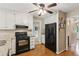Kitchen with white cabinets, granite countertops, and hardwood floors at 1405 Arden Trace Ln, Lawrenceville, GA 30043