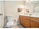 Bathroom with wooden vanity, large mirror, commode, and shower behind the curtain at 2657 Lenox Ne Rd # C38, Atlanta, GA 30324