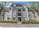 A well-maintained condo exterior showcases lush green hedges and reserved parking at 2657 Lenox Ne Rd # C38, Atlanta, GA 30324