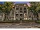 Beautiful condo building exterior with balconies, secure gate, and lush green landscaping at 2657 Lenox Ne Rd # C38, Atlanta, GA 30324