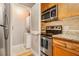 Galley style kitchen with stainless steel appliances and closet with stacked washer and dryer at 2657 Lenox Ne Rd # C38, Atlanta, GA 30324