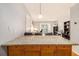 Open-concept kitchen island with marble countertops, view to the living space with sliding glass doors at 2657 Lenox Ne Rd # C38, Atlanta, GA 30324