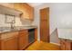 Close-up of kitchen featuring wooden cabinets, tile backsplash and stainless steel dishwasher at 2657 Lenox Ne Rd # C38, Atlanta, GA 30324