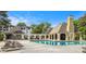 Outdoor community pool with lounge chairs and a covered building with seating and view of buildings at 2657 Lenox Ne Rd # C38, Atlanta, GA 30324