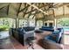Community poolside covered lounge with plush blue couches and view of the pool at 2657 Lenox Ne Rd # C38, Atlanta, GA 30324