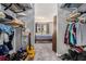 Walk-in closet with shelving and hanging clothes and view of carpeted bedroom at 2657 Lenox Ne Rd # C38, Atlanta, GA 30324