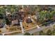 Aerial view showcases the home's setting amid mature trees, complemented by a neatly maintained lawn at 3850 Pilgrim Mill Rd, Cumming, GA 30041