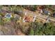 Aerial view shows the property's location among mature trees, featuring a spacious lawn and ample parking space at 3850 Pilgrim Mill Rd, Cumming, GA 30041