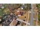 Aerial view of a property featuring a well-maintained lawn, mature trees, and ample parking at 3850 Pilgrim Mill Rd, Cumming, GA 30041