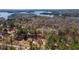 Aerial view of a neighborhood showcases waterfront views, mature trees, and picturesque homes by the lake at 3850 Pilgrim Mill Rd, Cumming, GA 30041