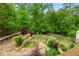 A lush backyard with walking path, framed by mature trees, offers privacy and a serene outdoor experience at 3850 Pilgrim Mill Rd, Cumming, GA 30041