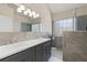 Elegant bathroom with dual sinks, modern fixtures, and a glass-enclosed shower, with natural light at 3850 Pilgrim Mill Rd, Cumming, GA 30041
