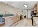 Open concept kitchen with modern appliances, stone countertops, eat-in bar, and wood-look tile floors at 3850 Pilgrim Mill Rd, Cumming, GA 30041