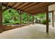 Covered patio with landscaped garden, perfect for relaxing or entertaining guests at 3850 Pilgrim Mill Rd, Cumming, GA 30041