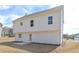 Back exterior view of home with white siding, windows and a small patio at 500 Charleston Pl, Villa Rica, GA 30180