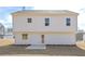 Back exterior view of home with white siding, windows and a small patio at 500 Charleston Pl, Villa Rica, GA 30180